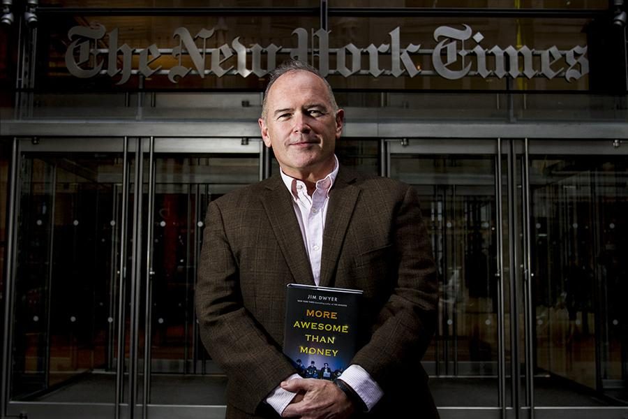 Columnist Jim Dwyer stands in front of the New York Times building with his new book, More Awesome than Money, about four NYU undergraduates who attempted to create a new social network.