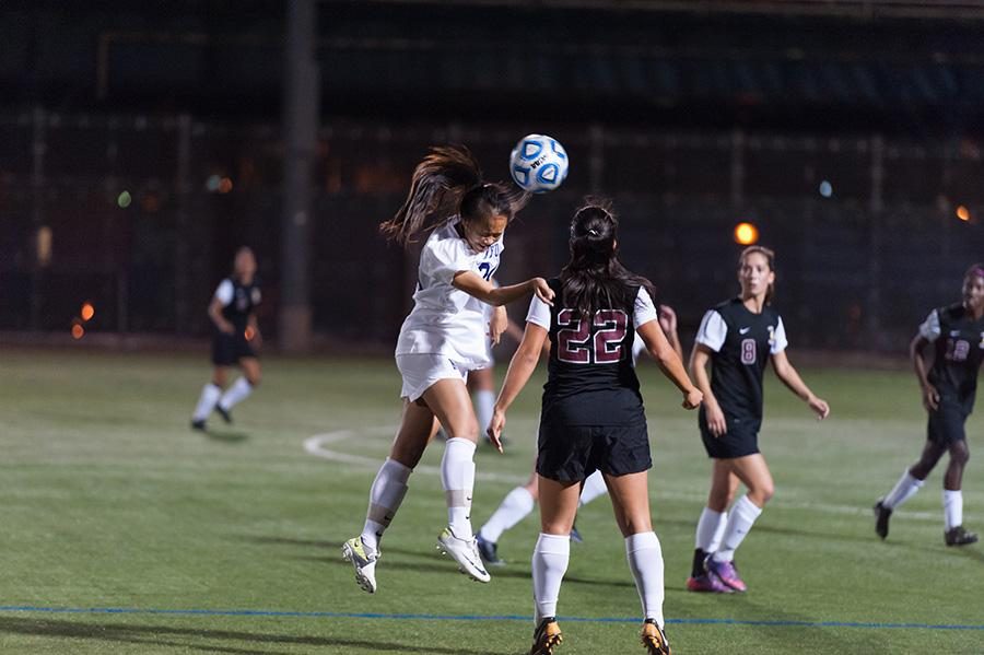 A Lady Violet headbutts the ball in the teams 4-0 shutout against Brooklyn College.