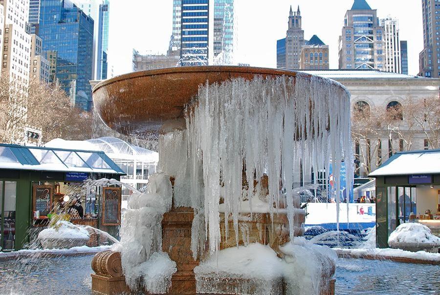 In Bryant Park a fountain freezes over in the cold of winter.