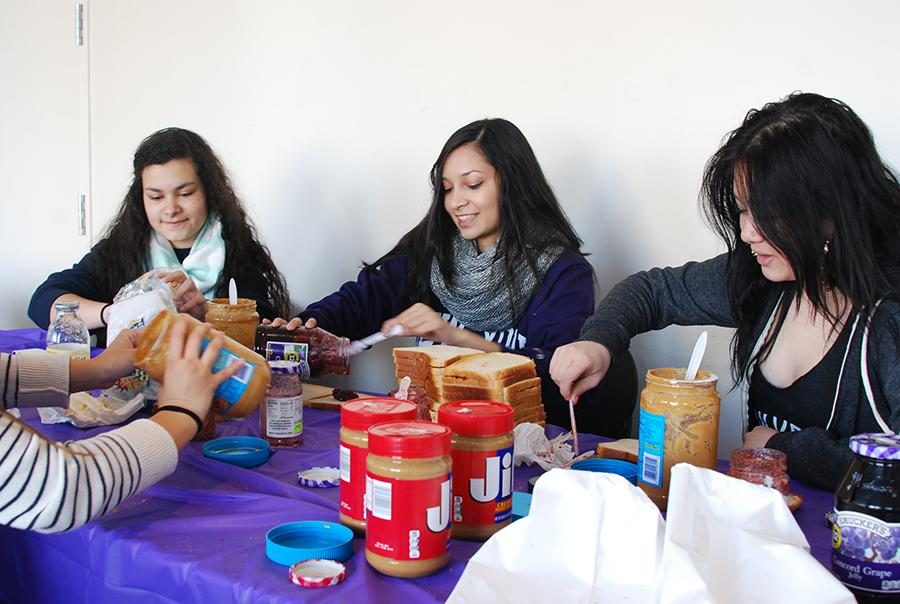 Sarah Vaz, Sohanna Islam and Shela Wu, left to right, make peanut butter and jelly sandwiches for Bowery Mission in Kimmel on Monday.