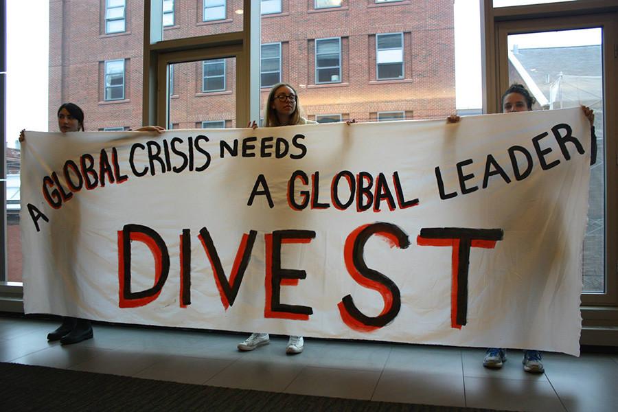 Members of NYU Divest demonstrate during the University Senate meeting last Thursday.