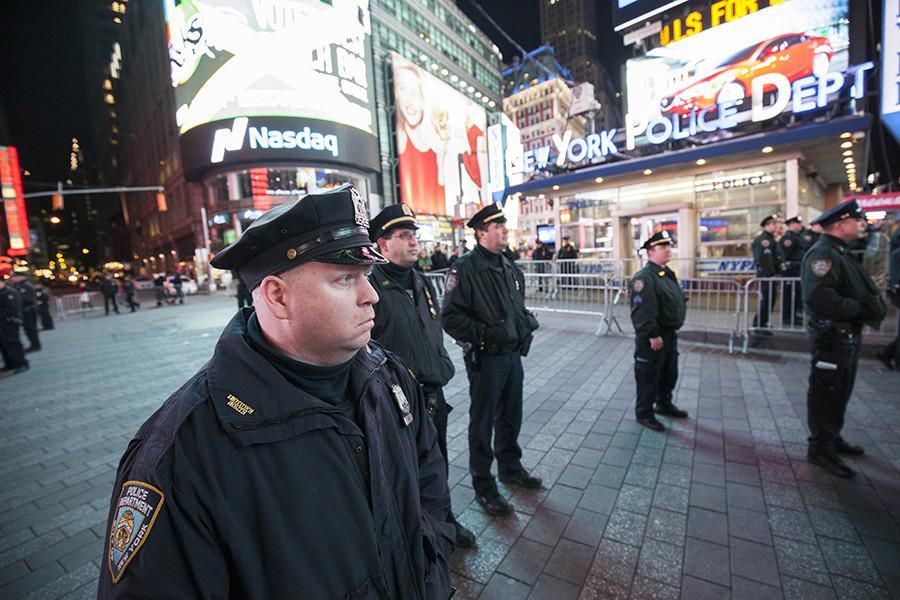 Police officers stand in Times Square following the Eric Garner decision.