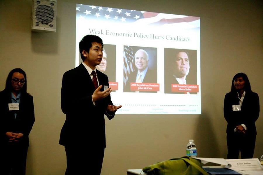 Joe+Wang%2C+center%2C+presents+on+domestic+policy.+His+team%E2%80%99s+presentation+won+the+final+round+of+NYU%E2%80%99s+second+Public+Policy+Case+Competition+on+Saturday.