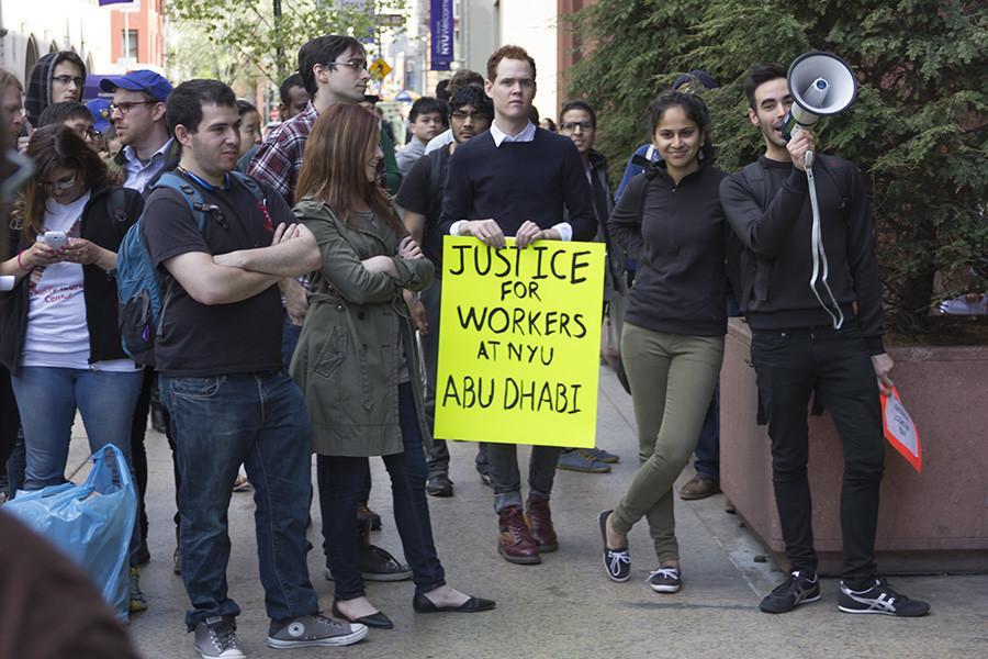 Protesters rally outside of Bobst for the compensation of Abu Dhabi workers affected by labor rights violations on Friday.