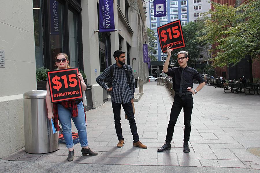 Haley Quinn, Vishnu Bachani, and Aaron Petykowski (from left to right) of NYU’s Student Labor Action Movement (SLAM) protest in front of the NYU Welcome Center on Friday, Oct. 9, 2015, advocating a raise in student worker pay to $15 an hour. 
