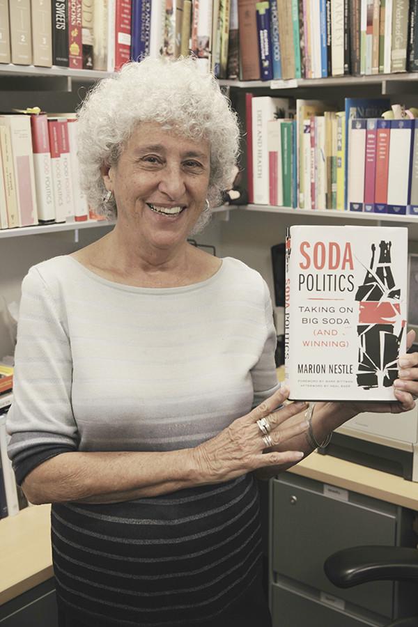 Marion Nestles showcases her new book “Soda Politics: Taking on Big Soda (and Winning)” in her office. 
