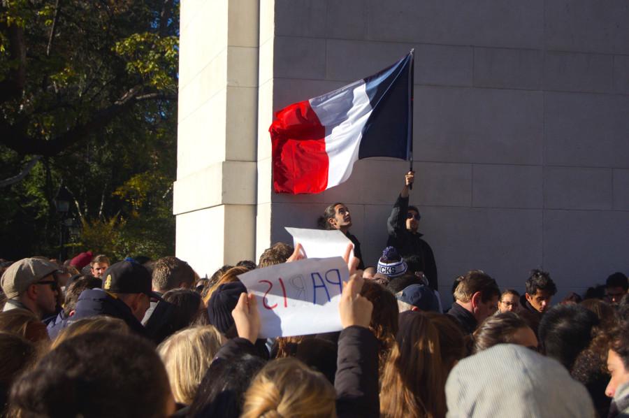 Hundreds gathered in Washington Square Park on Saturday, waving French flags and signs of solidarity with Paris.
