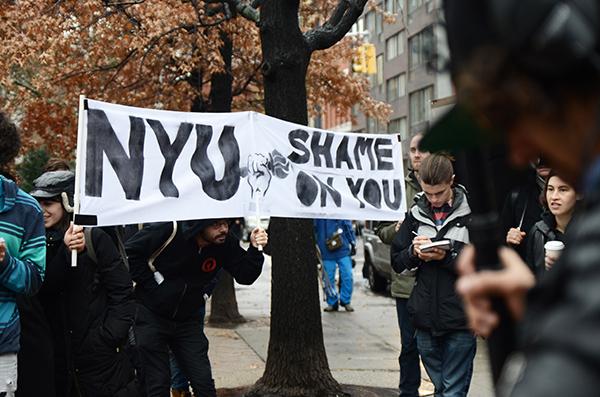 Crowds rally in front of Coles Sports Center on Wednesday, December 2, for the NYU Walk of Shame, organized by GSOC/UAW, the union for graduate employees at NYU.