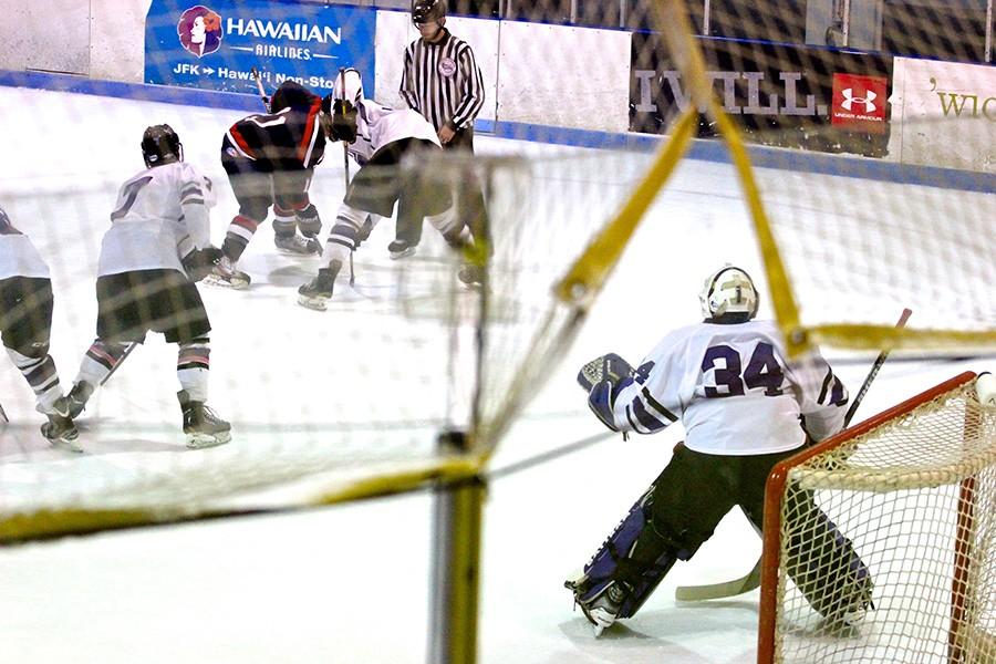 The NYU Hockey Teams goalie, Sam Daley, gets ready during a defensive zone faceoff.
