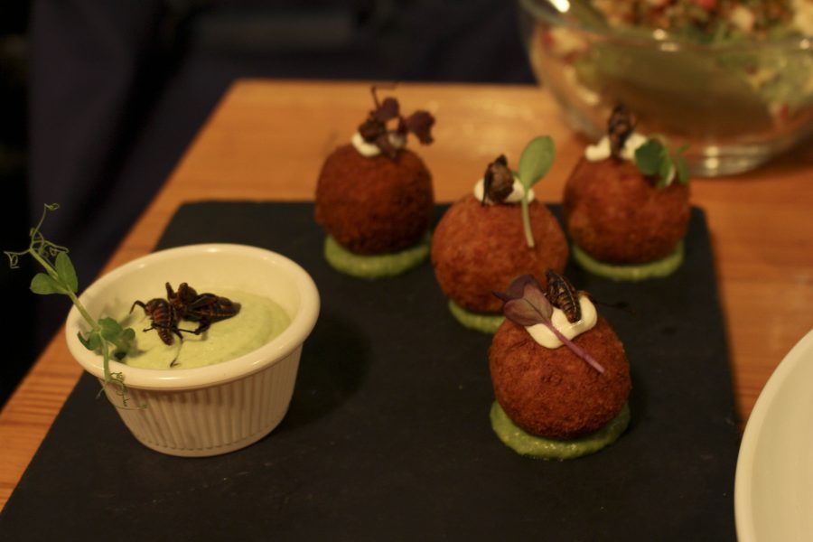 Potato croquettes with a side of salsa verde. Topped with grilled grasshoppers.
