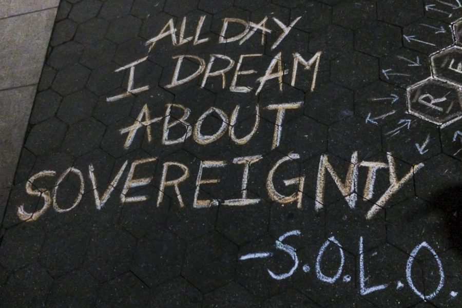 The NYU Native American and Indigenous Students Group protested in Washington Square Park with posters and sidewalk chalk.
