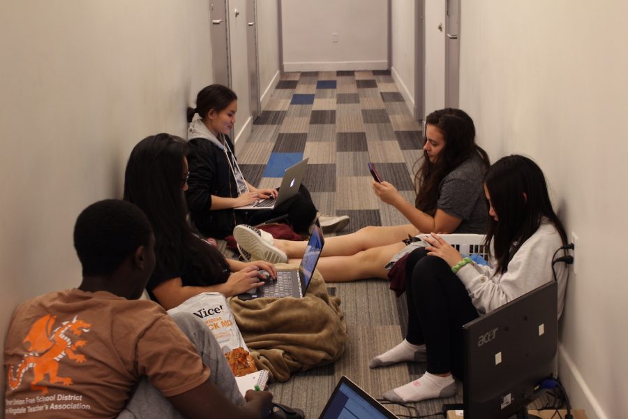 Friends work on schoolwork in Brittany Residence Hall, allowing them to be productive while getting to know each other. 