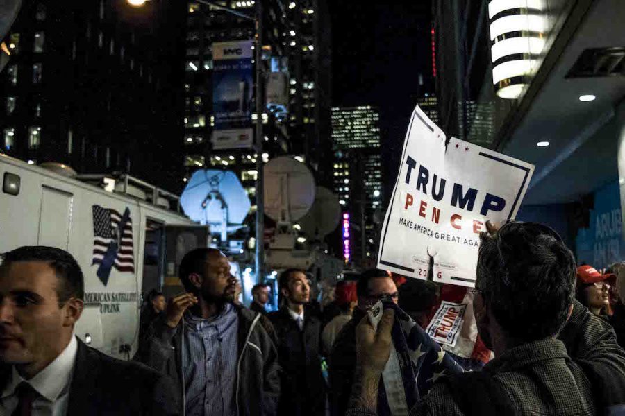 A Trump/Pence sign outside of the Hilton being waved on Election Night