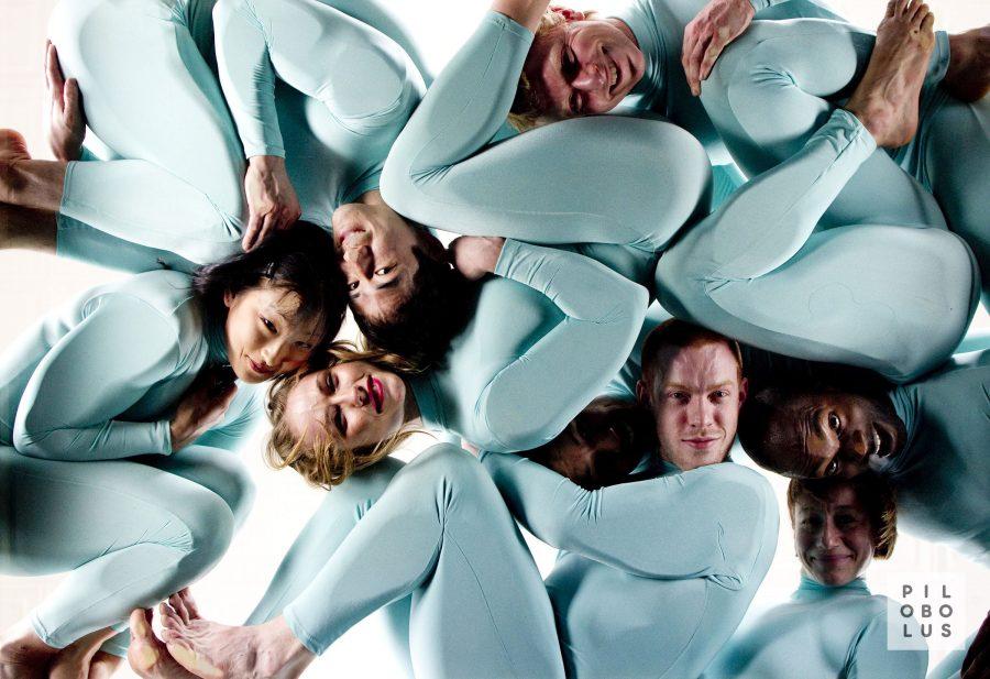 NYU Tisch alum, Sayer Mansfield, pictured in the center wearing red lipstick, is one of the performers in Pilobolus, which is now at Skirball.
