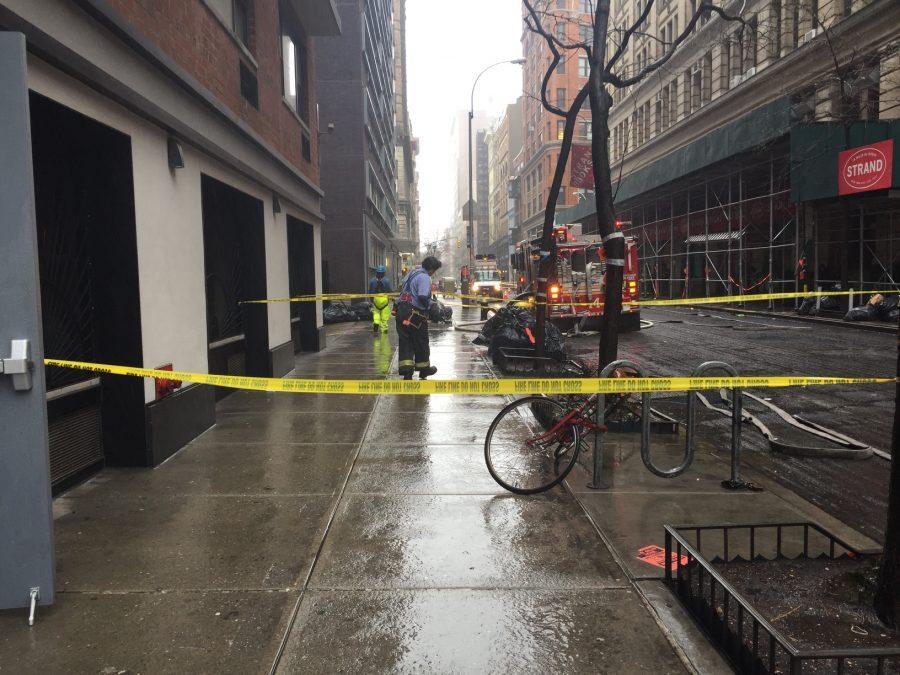 Fire officers work to control the fire next to the Strand bookstore, which broke out on 12th Street following an explosion this morning.