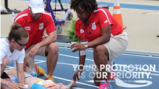 Along with his colleagues, Matthew Devens, pictured in the center, helps a girl that collapsed at the High School Track and Field Nationals, which took place at Greensboro North Carolina in 2013.