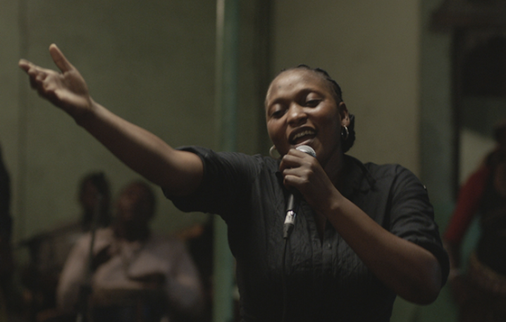 Félicité is a free-willed woman working as a singer in a bar in Kinshasa. Her life is thrown into turmoil when her 14-year-old son gets into a terrible car accident and in order to raise money to save him, she sets out on a breakneck race through the streets of electric Kinshasa – a world of music and dreams.