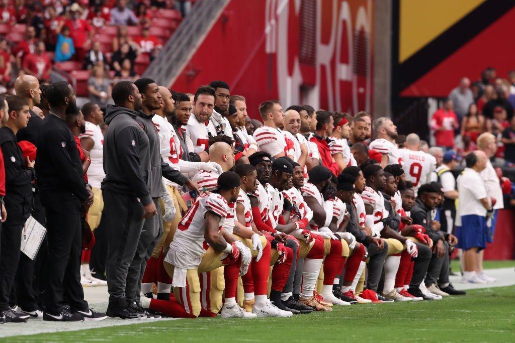
30 players from Kaepernick’s former team, the San Francisco 49ers, kneel during the national anthem before their game on Oct 1, 2017.
