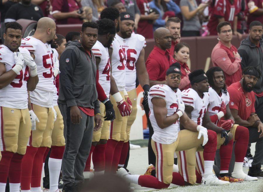 Various+NFL+players+have+knelt+during+the+playing+of+the+playing+of+the+national+anthem+to+protest+police+brutality+and+racial+violence.+Critics+have+labelled+these+players+as+anti-militaristic%2C+so+many+players+chose+to+stand+on+veterans+day+out+of+respect+to+the+military.