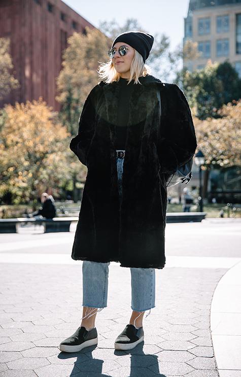 A stylish New Yorker sports a faux fur coat in Washington Square Park.