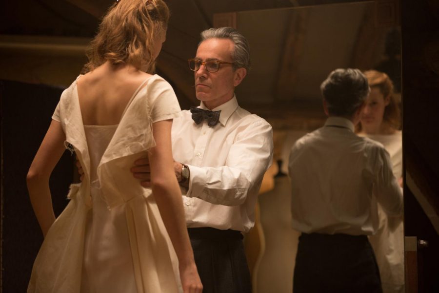 Reynolds Woodcock, played by Daniel Day-Lewis, fits a dress on Alma, played by Vicky Krieps, in a scene from “Phantom Thread.”