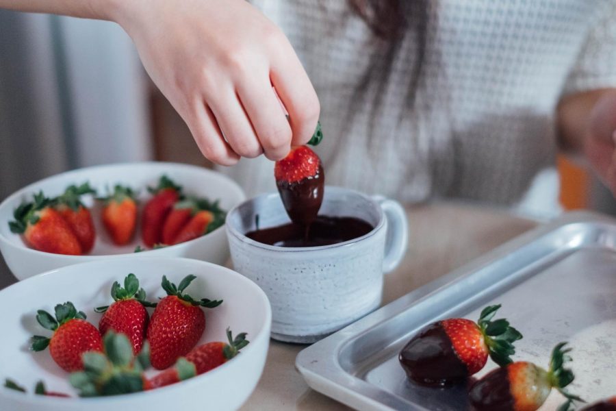An NYU student makes chocolate strawberries in preparation for Valentine’s Day.