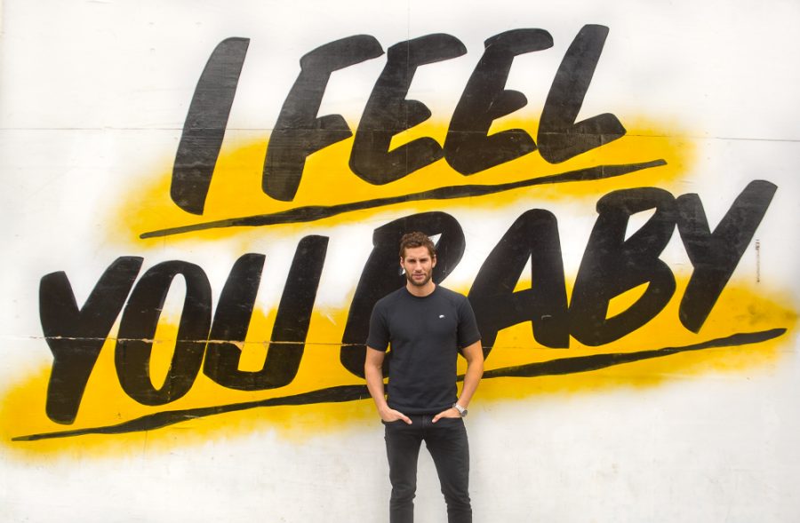 Chef Franco Noriega outside his restaurant, Baby Brasa in West Village in front of a mural that is part of his art collective “The New Allen.”