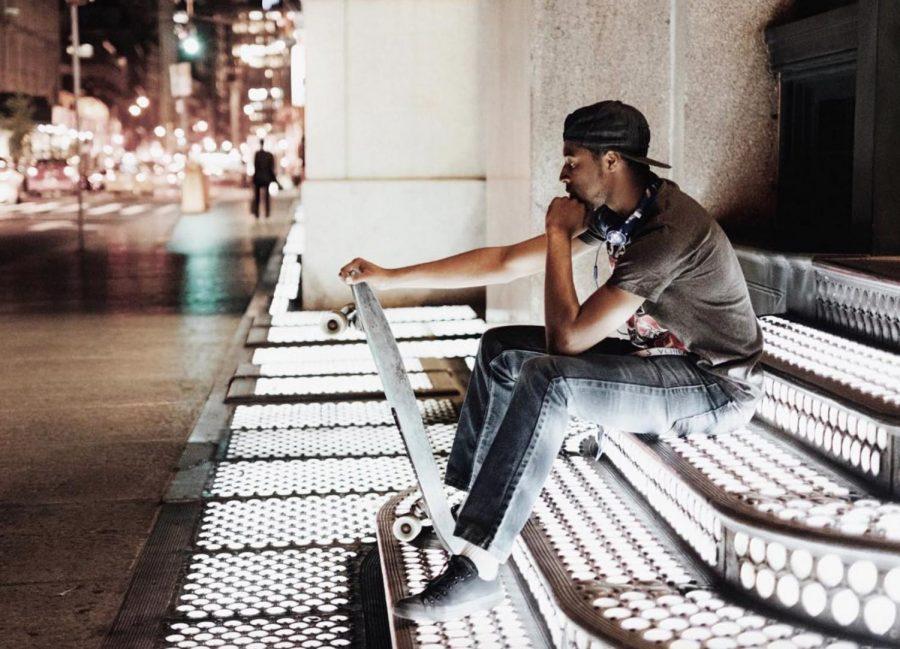 An NYU skateboarder takes a break from skating around Lower Manhattan. 