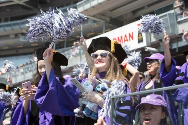 Students cheering at Yankee Stadium during NYU’s 2017 Commencement.