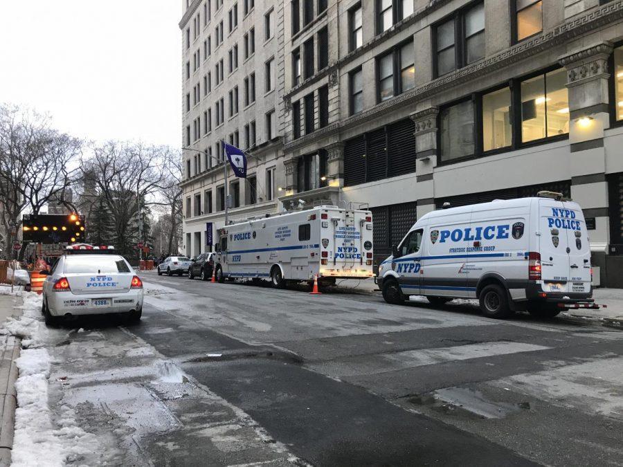 NYPD vans are parked in front of the NYU Academic Resource Center. (Staff Photo via Veronica Liow) 