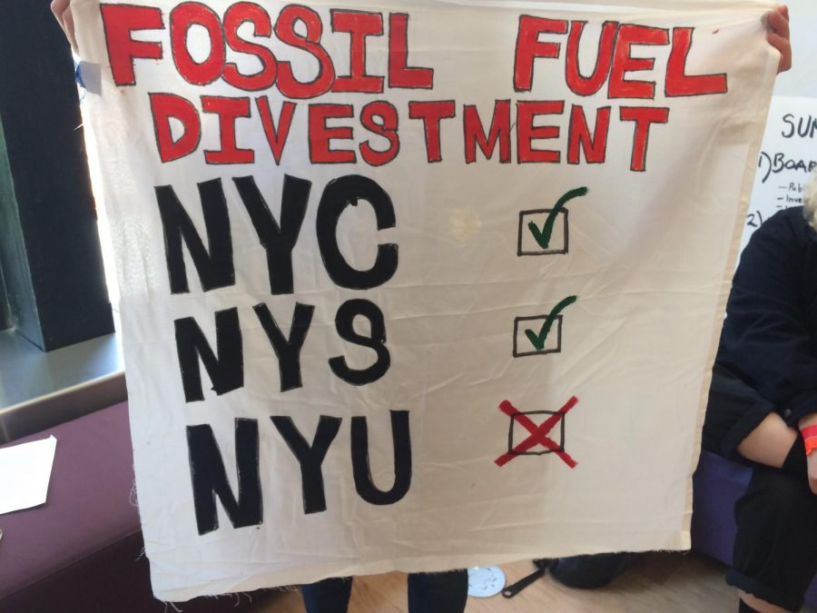 Demonstrators displayed posters advocating for fossil fuel divestment and improved student representation.