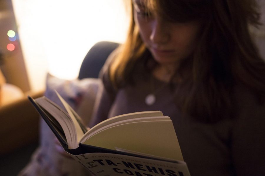 A student reads in her common room.