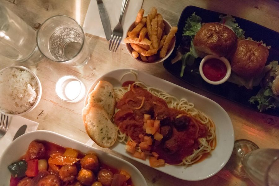 Sweet and sour chicken with white rice, spaghetti and meatballs with garlic toast, and sausage sliders with French fries.