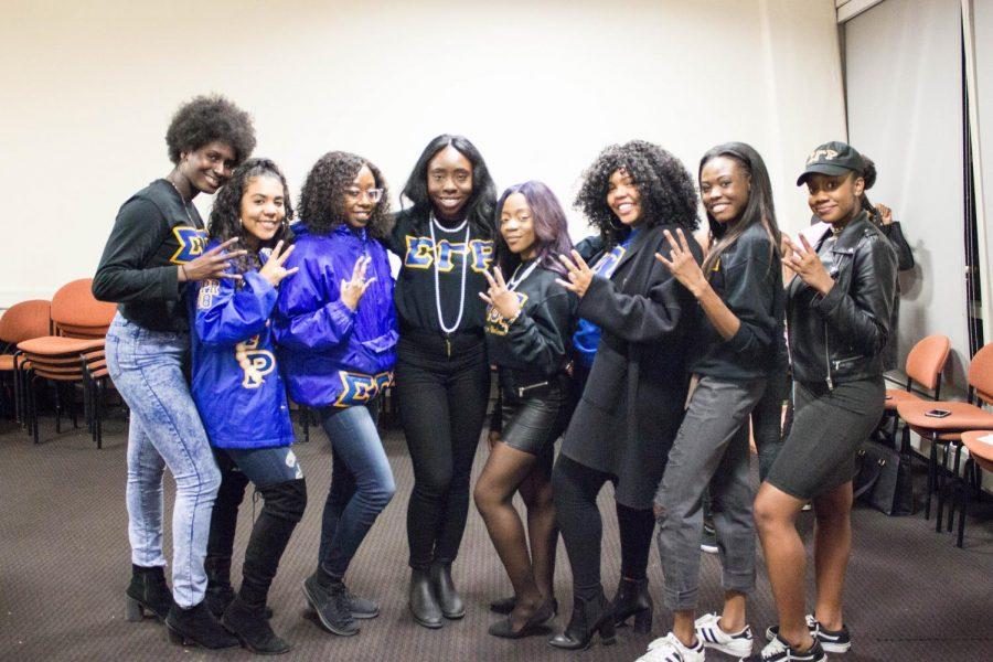 Members of the Tau Epsilon chapter of Sigma Gamma Rho Sorority, Inc. pose with their Sigma hand sign after co-hosting an event in Kimmel on Tuesday.