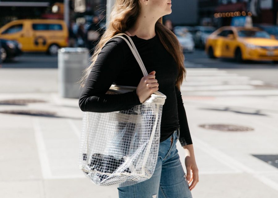 An NYU student carries a clear handbag from Urban Outfitters.