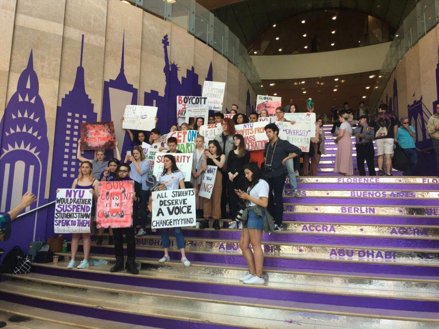 Prospective students and their guests walk up and down the steps of the Kimmel Center of University in the midst of activists protesting for a town hall meeting with trustees.