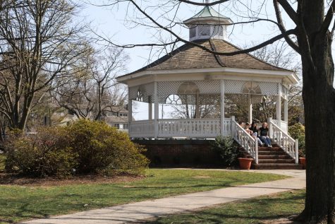A gazebo on a grassy field is a popular spot for locals to picnic.