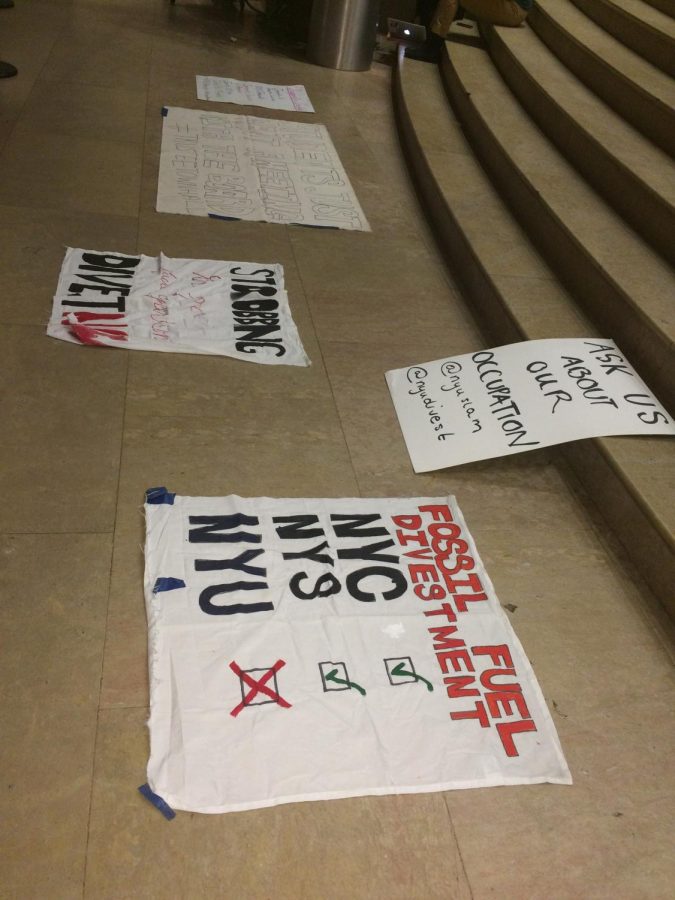 Signs belonging to the protestors, detailing their desires for NYU to divest from the use of fossil fuels.