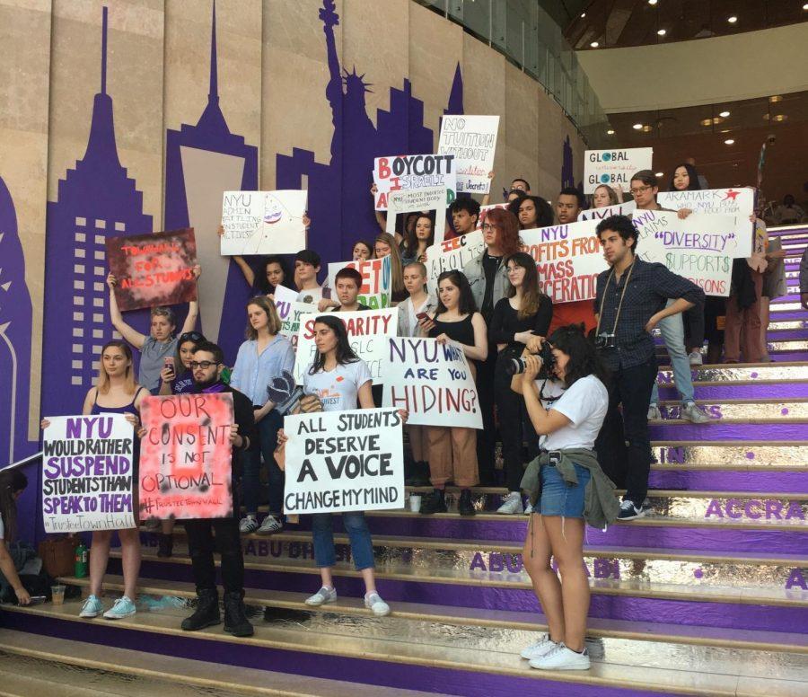 Student activists gather on the staircase of the Kimmel Center for University Life during Weekend on the Square to protest for a meeting with the Board of Trustees