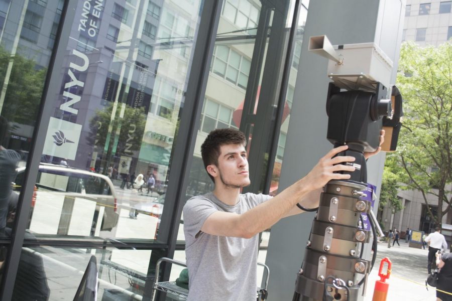A student taking measurements of the way that millimeter waves travel and react in Downtown Brooklyn at Tandon.