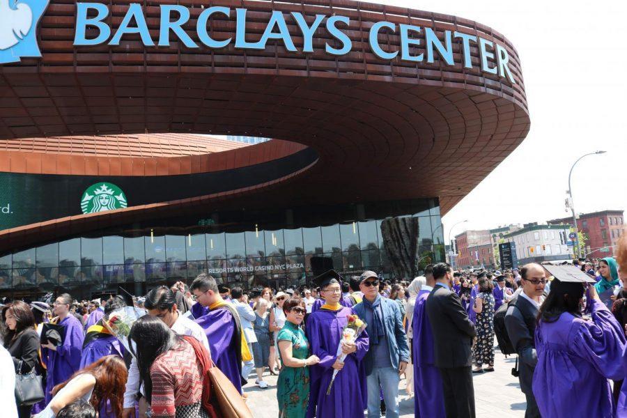 Graduates pose for photos with friends and family outside the Barclays Center where Tandons graduation ceremony just took place.