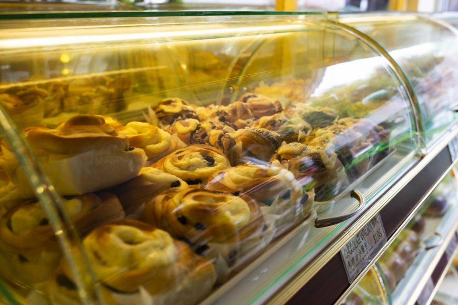 Chocolate walnut buns piled on each other in a case.