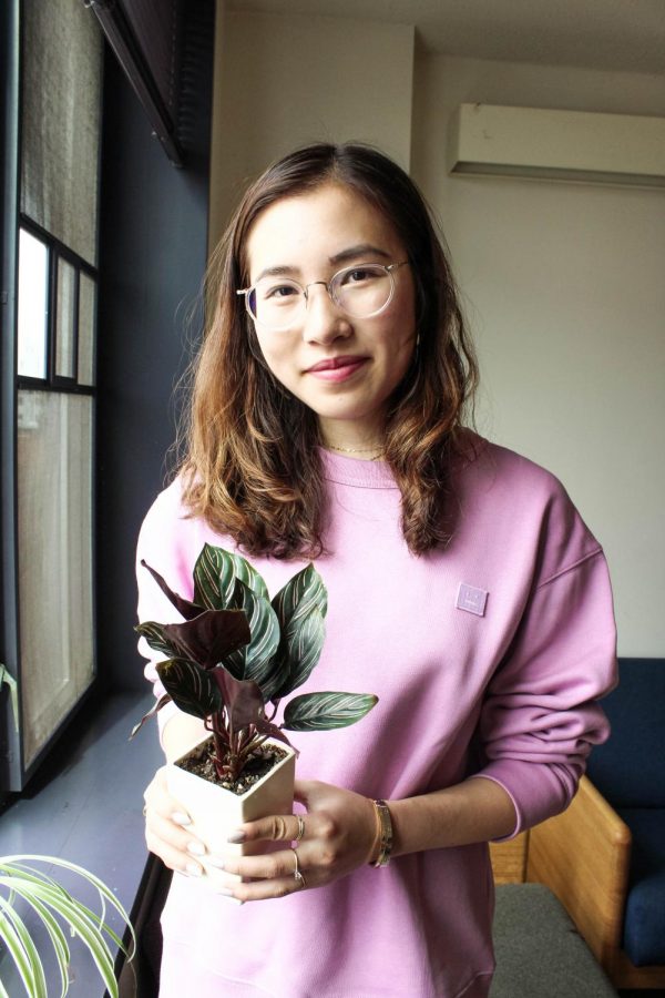 CAS sophomore Michelle Xu poses with her prayer plant, one of her six total, in her dorm room in Palladium Residence Hall.