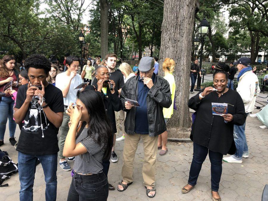 Attendees+were+given+harmonicas+and+music+sheets+to+follow+along+with+NYU+Steinhardt+Director+of+Jazz+Studies+David+Schroeder%2C+who+conducted+the+song.