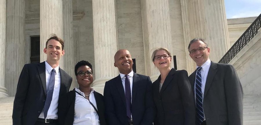 NYU Law Professor Bryan Stevenson (middle) surrounded by colleagues on steps of the Supreme Court. (Courtesy of Equal Justice Initiative)