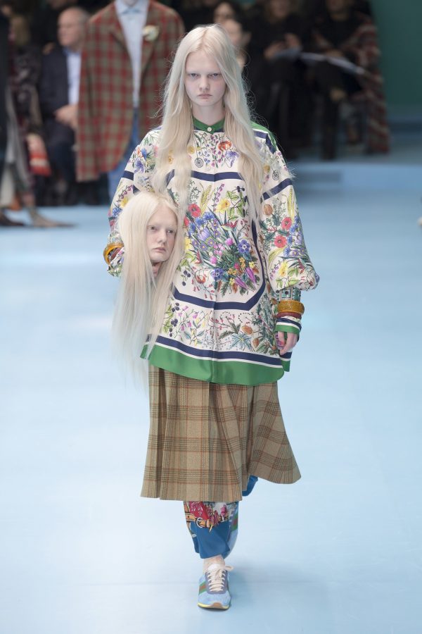 A camp-style runway look from Gucci F/W 18, where a model carries a replica of her own head. (via vogue.com)
