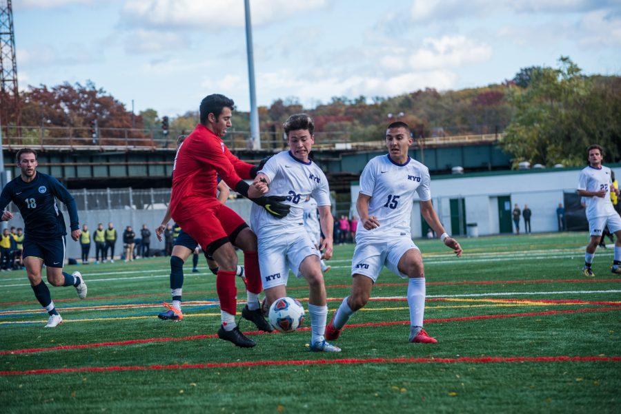 Oliver+Kleban+forces+his+way+around+the+opposing+goalkeeper+before+scoring+in+the+final+minute+of+a+2018+game+against+Brandeis+University.+%28Photo+by+Sam+Klein%29