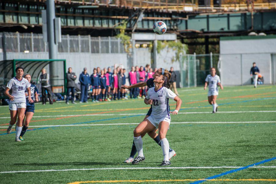 Senior Maddie Peña fights for a header in a win over Brandeis University on Nov. 3. (Photo by Sam Klein)