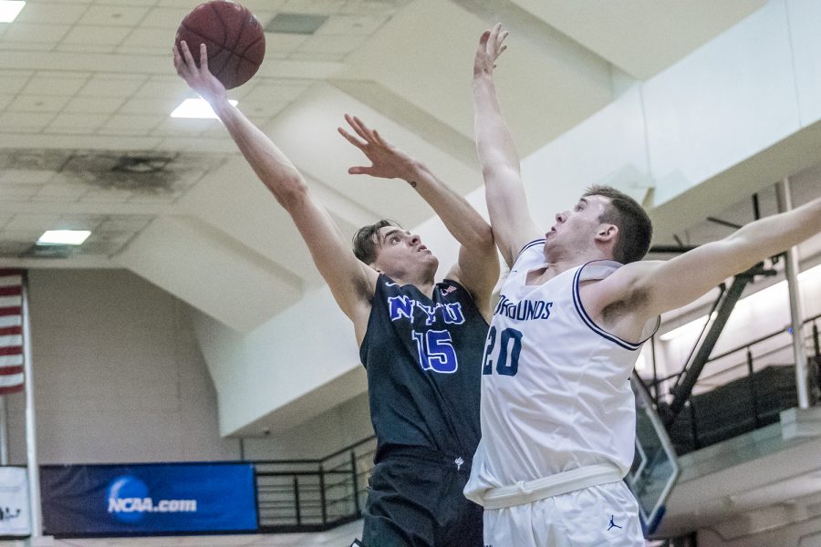 Oscar Argemi Gonzalez takes a layup in a game against John Jay on Nov. 20, which NYU won. (Photo by Sam Klein)