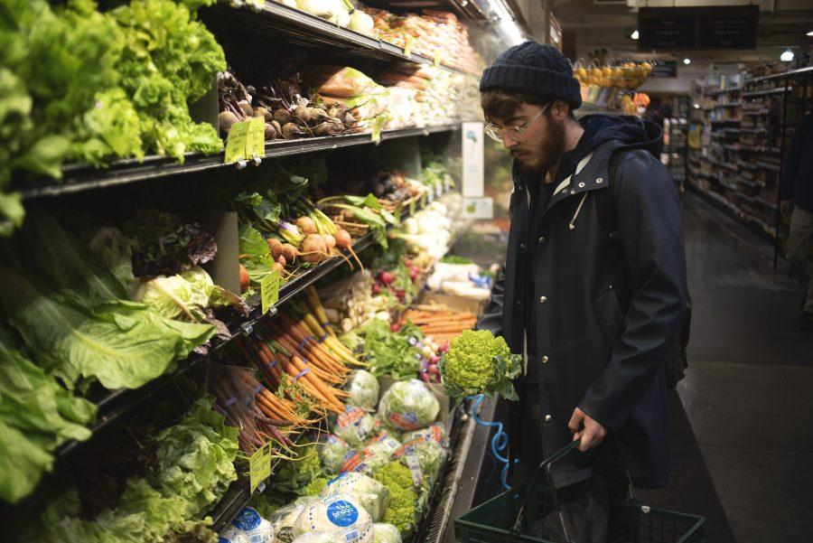 Student chef Nino Asaro aims to purchase the freshest vegetables. (Photo by Justin Park)